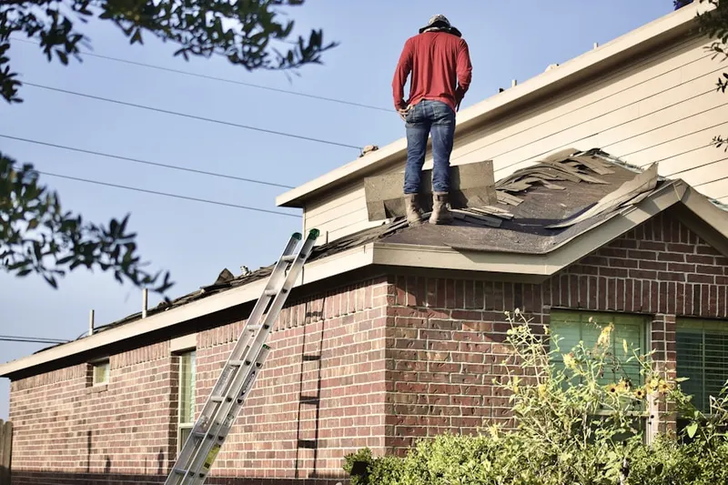 Professional roofer working on a residential roof in Boonville